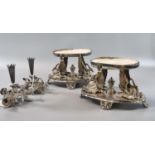 Pair of silver plated stands with swan form mounts, central finials and shell feet, probably