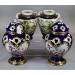 Pair of Japanese porcelain vases hand painted with vignettes of flowers and a landscape together
