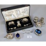 Cased set of silver condiments with blue glass liners, to include: mustard pots, spoons etc,