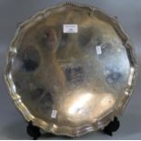 Early 20th century silver presentation pie crust salver standing on ball and claw feet, inscribed