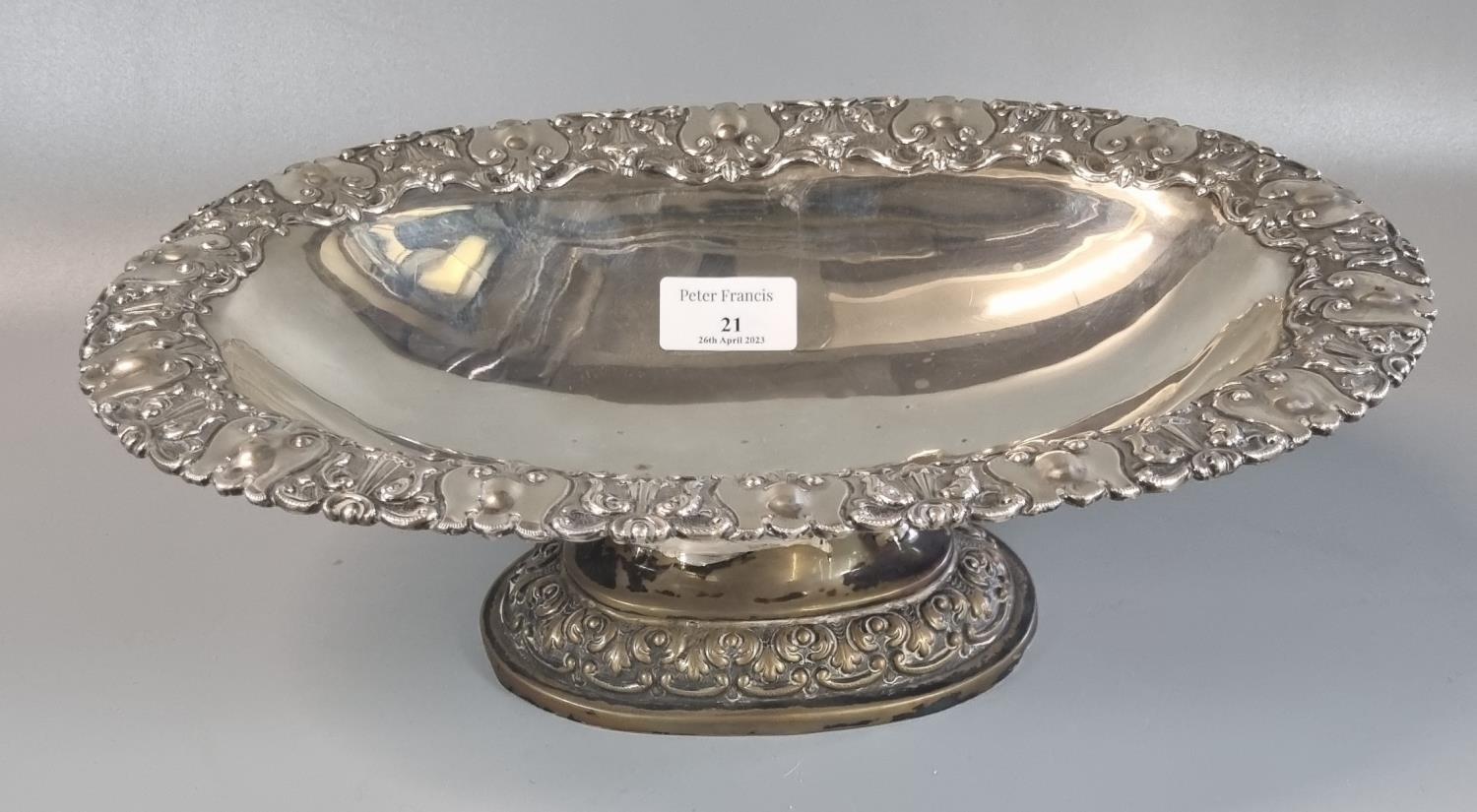 Indian white metal pedestal bowl of oval form ornately embossed with swags and foliage. 33x22x10cm