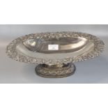 Indian white metal pedestal bowl of oval form ornately embossed with swags and foliage. 33x22x10cm