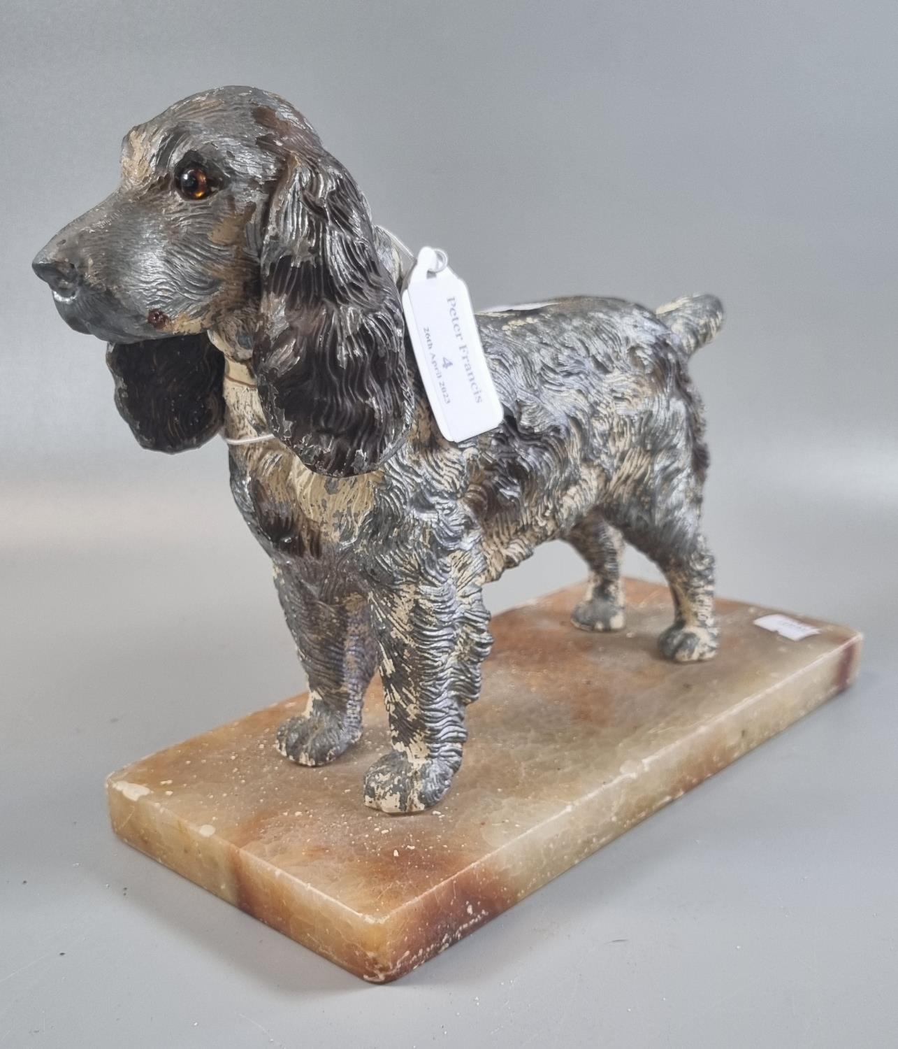 Art Deco spelter figure of a spaniel with naturalistic features and glass eye (one missing),