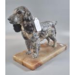 Art Deco spelter figure of a spaniel with naturalistic features and glass eye (one missing),