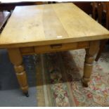 Late Victorian pine single drawer farmhouse table on baluster turned legs and casters. 125x92x76cm