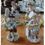 Pair of continental porcelain figurines of a man and woman in 18th century dress with basket of