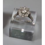 Diamond cluster ring set in 18ct white gold. The central brilliant cut diamond an estimated 0.