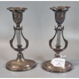 A pair of silver plated classical design lyre candlesticks. (B.P. 21% + VAT)