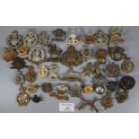 Collection of assorted British military cap badges including: Breconshire, The Norfolk Regiment,