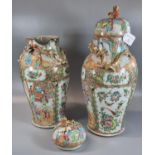 Pair of Canton famille rose baluster vases and covers, decorated all over with panels of figures