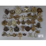 Collection of assorted British military cap badges including: The King's Own Borderers, Cornwall