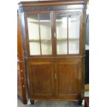 19th century Welsh oak glazed double corner cupboard with shaped shelves to the interior and two