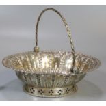 Silver pierced basket/bonbon dish with spiral design swing handle, indistinct but probably London