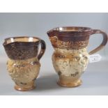 Set of two graduated late 19th Century Doulton Lambeth salt glaze baluster single handled jugs,
