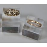 Two 9ct gold rings; one eternity ring set with white stones and a plain gold band, both ring size N.