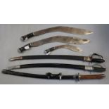 Two Indian ceremonial swords with scabbards, two large Kukri type ceremonial swords, a smaller