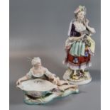 Continental figurine of a lady with basket of flowers together with another German probably