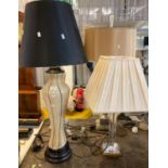 Modern table lamp with shade having tapering glass column on a copper finish square base together
