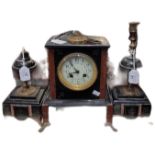 Early 20th century gilt metal and black slate clock garniture, the two train clock with urn