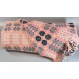 Vintage woollen Welsh tapestry pink ground blanket or carthen with traditional Caernarfon design and