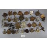 Large collection of British Military cap badges, including: The Royal Dragoons, Cheshire Regiment,