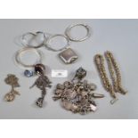 Bag of assorted costume and silver jewellery, various to include: bangles, brooches, charms, charm
