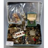 Metal tin containing a large collection of Military and other buttons, pin badges, enamel badges,