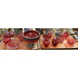 Two trays of mainly Victorian cranberry glass items together with a paperweight in the form of an