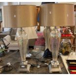 Pair of modern table lamps with shades having iridescent glass crackle glaze column on a chrome