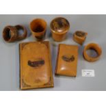 Plastic tub of assorted assorted Mauchline Ware, to include: napkin rings, thimble case, beakers