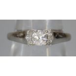Diamond solitaire ring set in 18ct white gold with three diamonds set to either side. Ring size P