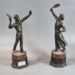 Pair of bronzed spelter figures of Edwardian tennis players on simulated marble base and socles.