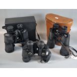 Pair of Prinz 12:50 binoculars in pigskin case, a pair of Super Zenith 10:50 binoculars in hard case