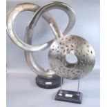 Modern metal silvered abstract sculpture on circular base together with a metal pierced candle