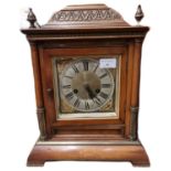 Early 20th century German two train walnut cased architectural mantle clock with brass face having