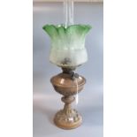 Early 20th century double burner oil lamp having frosted green glass shade on a copper reservoir and