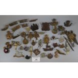 Collection of assorted Military cap badges and other insignia, including: Monmouthshire Regiment,