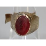 Yellow metal ring with a red stone (cut), 3.5g approx. (B.P. 21% + VAT)