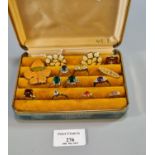 Ring box comprising: assorted dress rings with coloured stones, enamel leaf brooch and enamel pair