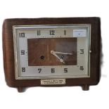 Art Deco design two train rectangular shaped presentation mantle clock in walnut case.