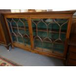 19th century mahogany two door glazed bookcase, the interior revealing two fitted shelves above an