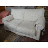 Good quality modern cream ground foliate upholstered two seater sofa with shaped arms standing on