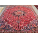Red and blue ground vintage Persian carpet, overall decorated with flowers and foliage. 310x220cm