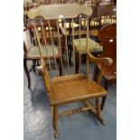 Modern beech spindle back rocking armchair. (B.P. 21% + VAT)