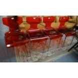 Set of four red Perspex chairs on chrome frame, the backs marked 'MB'. (4) (B.P. 21% + VAT)