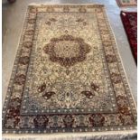 20th century Persian design carpet on a cream ground with central flowerhead medallion surrounded by