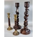 Two pairs of modern spiral wooden candle sticks, one with brass mounts. 30cm high and 48cm high