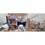 Two unusual vintage doll's houses in the form of a shop and large timbered house with conservatory