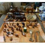 Two trays of carved African and other wooden items, mostly animals to include: elephant bookends,
