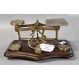 Set of 19th century brass letter scales and weights on serpentine shaped mahogany base. (B.P.